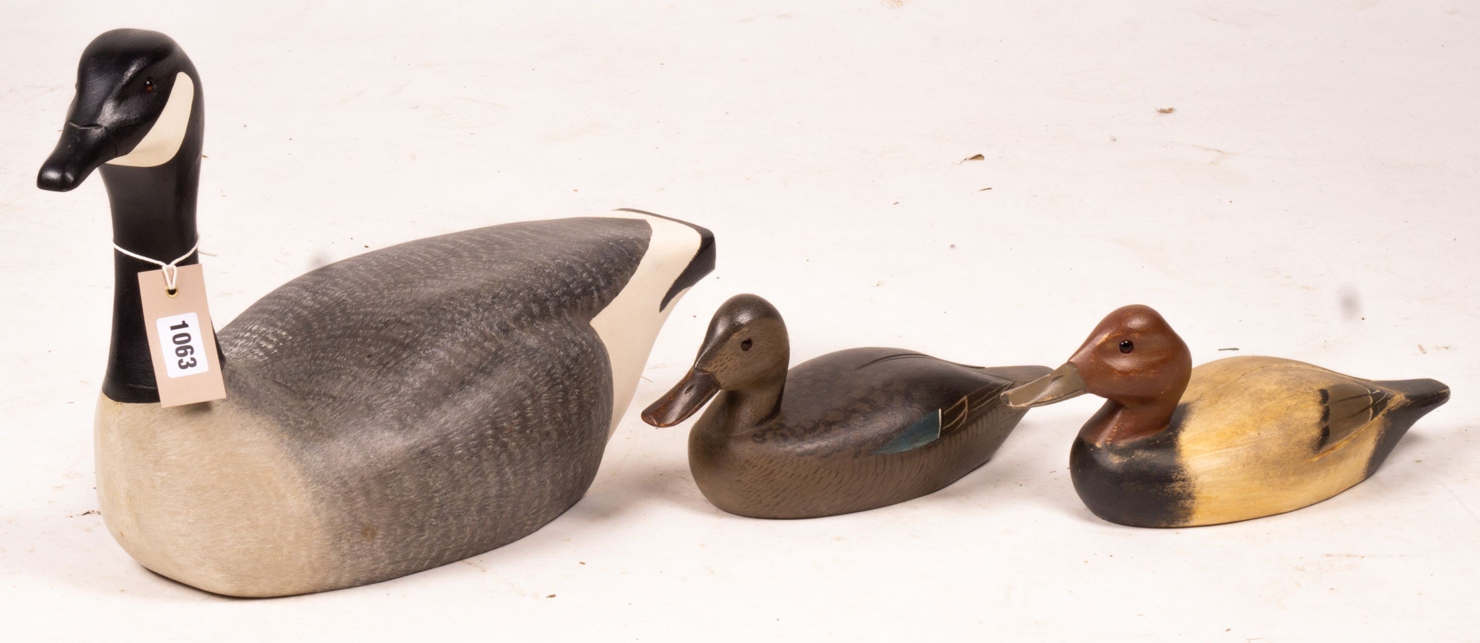 Three American carved and painted decoy duck ornaments, largest 48cm long